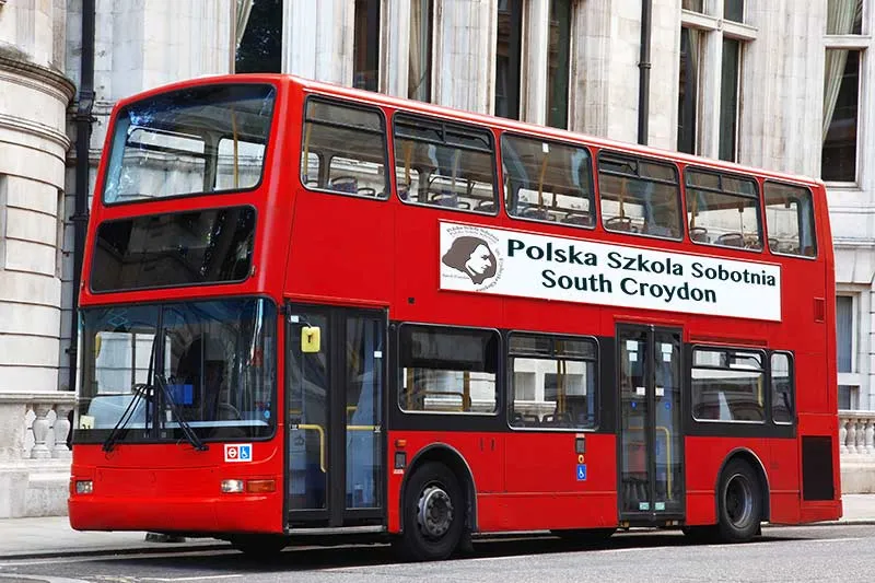 Illustrative red bus with the school's graphics